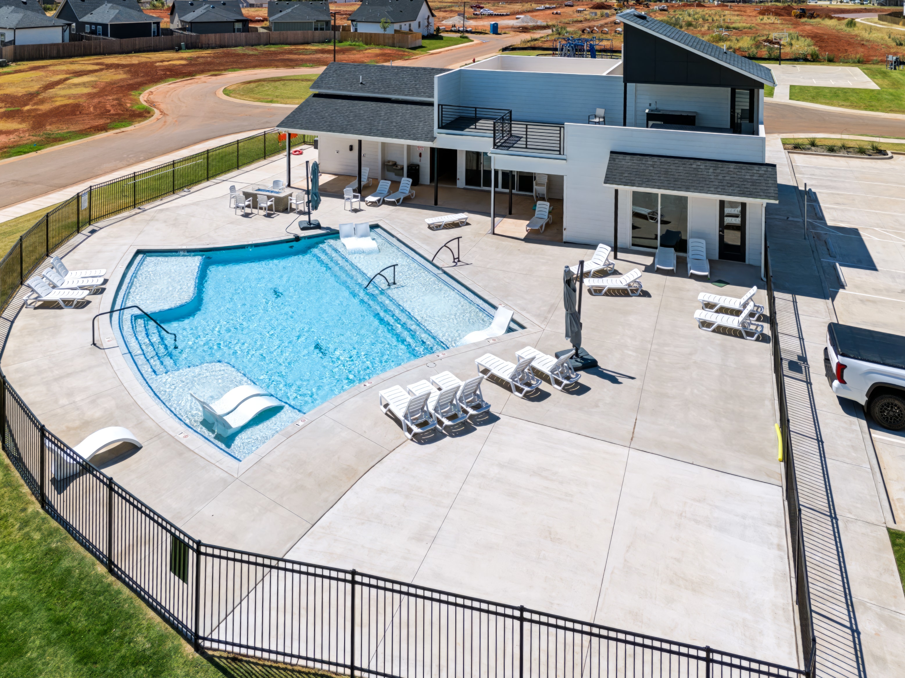 Aerial view of residential pool and modern home